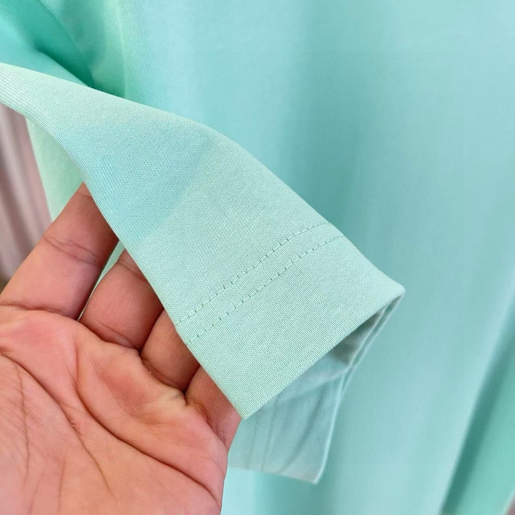 Turquoise T-shirt sleeve hem with neat stitching detail