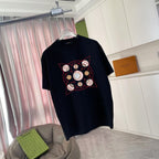 Louis Vuitton black crewneck T-shirt with red and gold circular graphic, front view