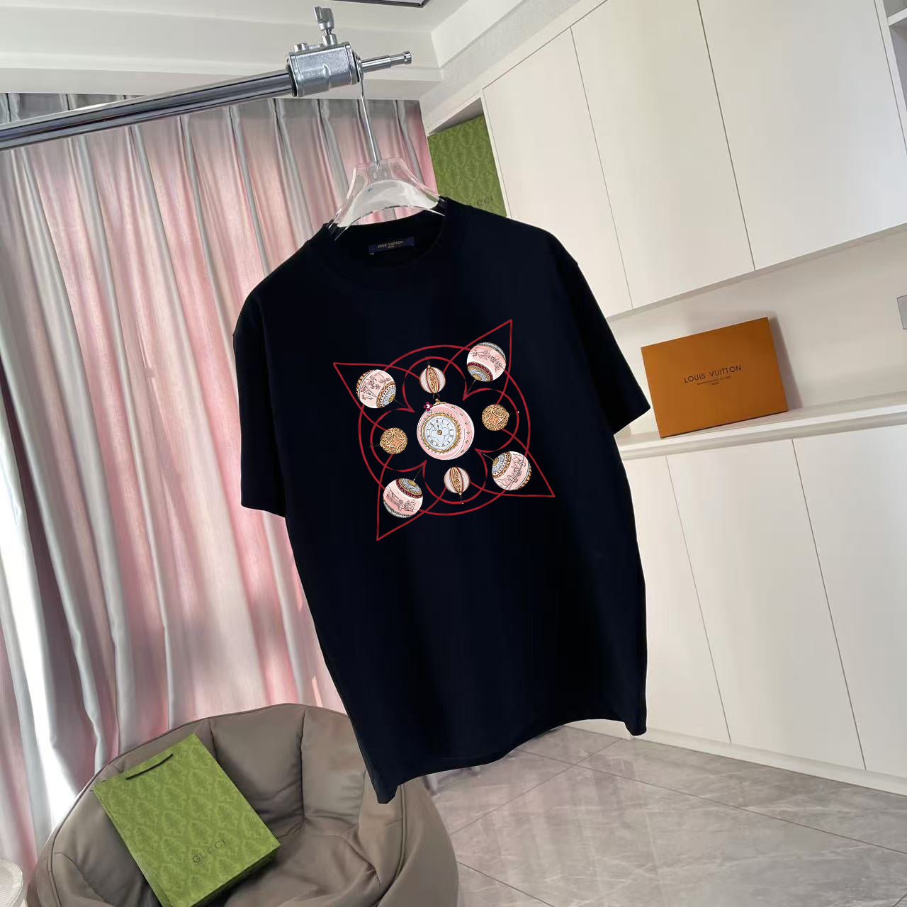 Louis Vuitton black crewneck T-shirt with red and gold circular graphic, front view