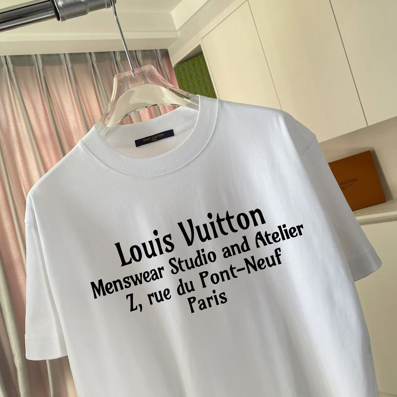 White short-sleeve T-shirt with large black logo typography