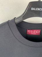 Gucci crewneck T-shirt collar with red Gucci label at neckline, dark blue