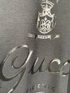Gucci front graphic close-up with “Gucci” text and crest, dark blue