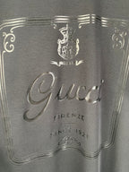 Gucci graphic panel close-up with crest and “Firenze” text, dark blue