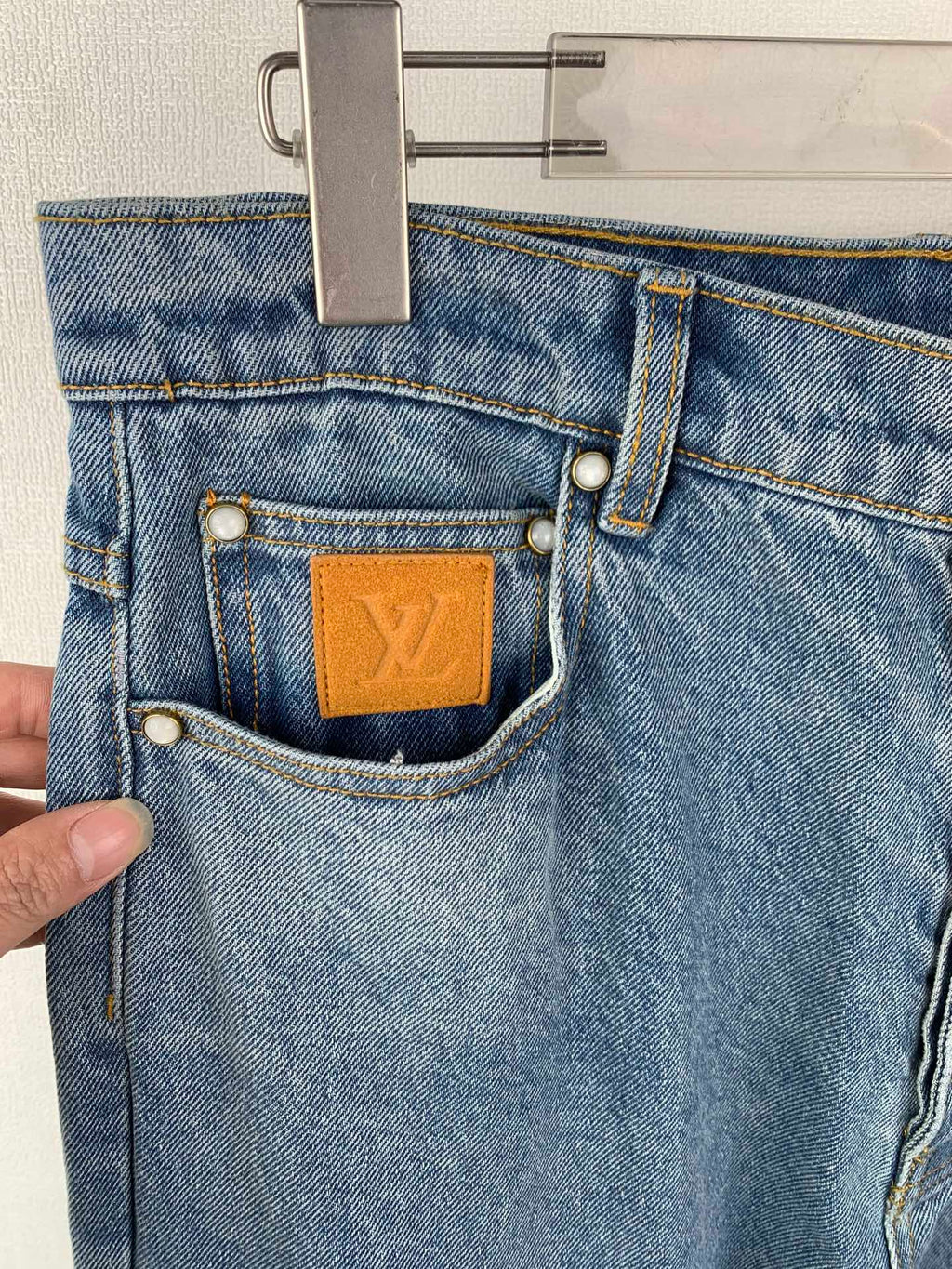 Louis Vuitton light blue denim pants with front coin pocket and tan LV leather patch