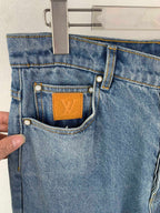 Louis Vuitton light blue denim pants with front coin pocket and tan LV leather patch