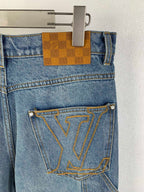 Louis Vuitton light blue denim pants with tan check pocket tab and LV-stitched emblem