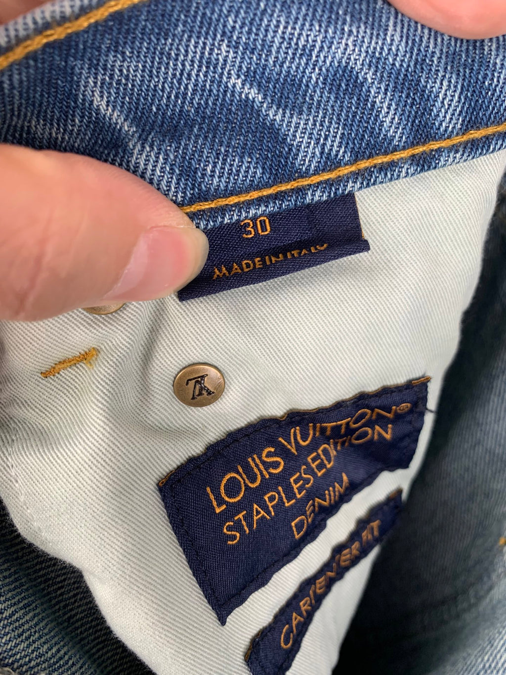 Denim pants with size tag 30 and Louis Vuitton Staples Edition label