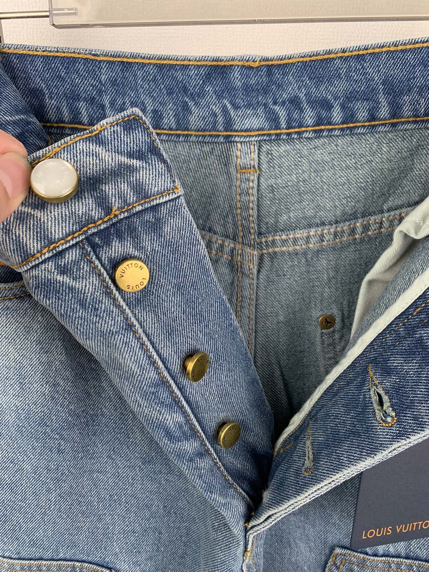 Denim pants with button closure, belt loops, and stitched front pockets