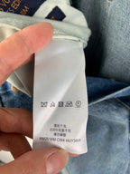 Denim pants with interior care label showing washing symbols and model code