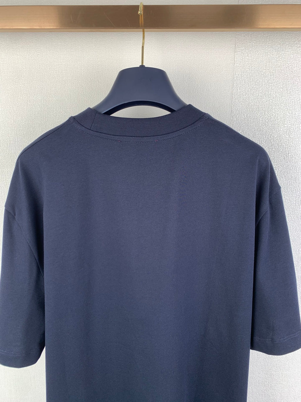 Navy short-sleeve T-shirt back view, showing crew neck and shoulders