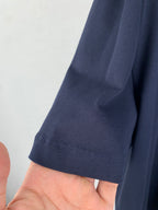 Navy short-sleeve garment cuff with stitched hem and seam detail