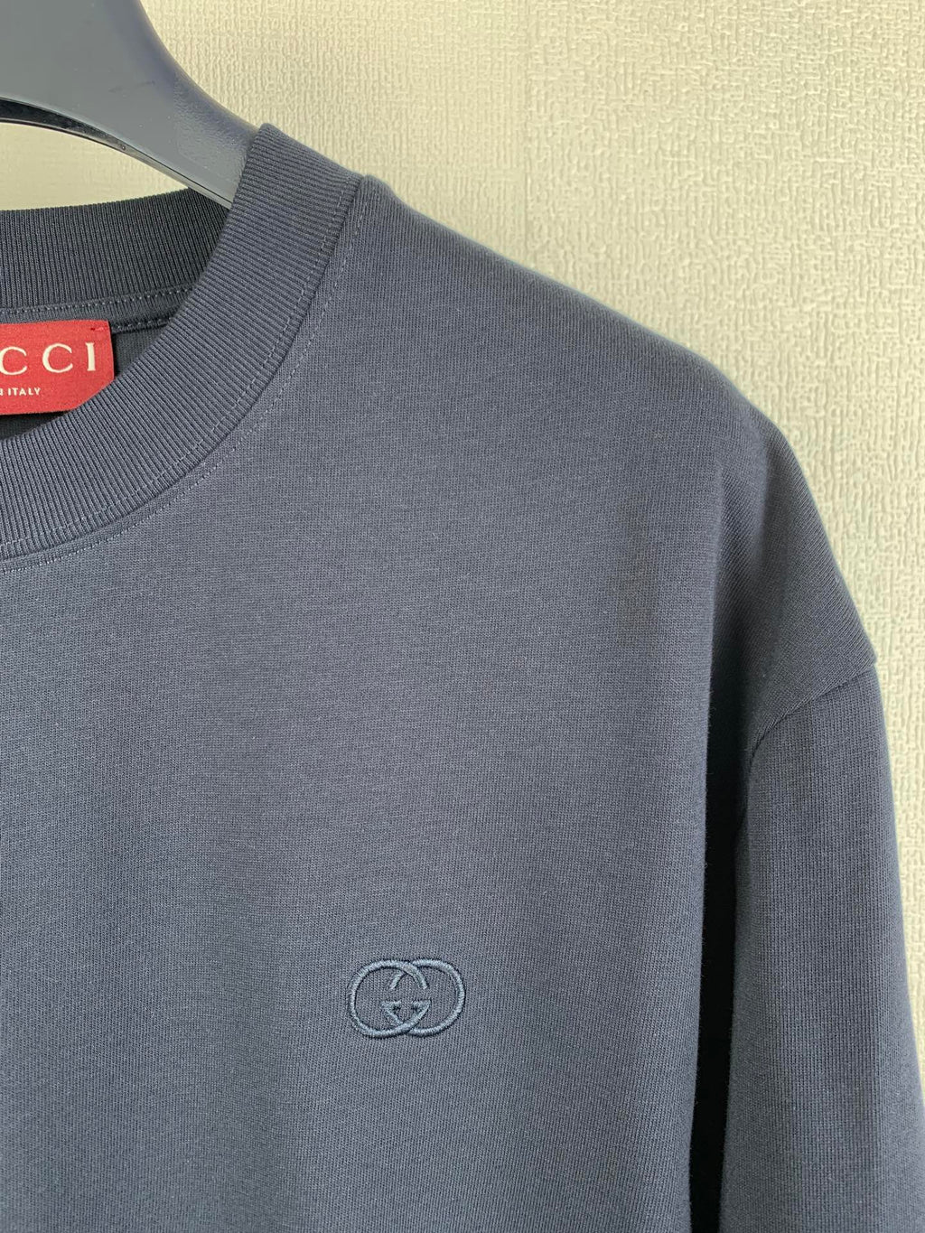 Navy T-shirt with small embossed Gucci double-G logo at chest