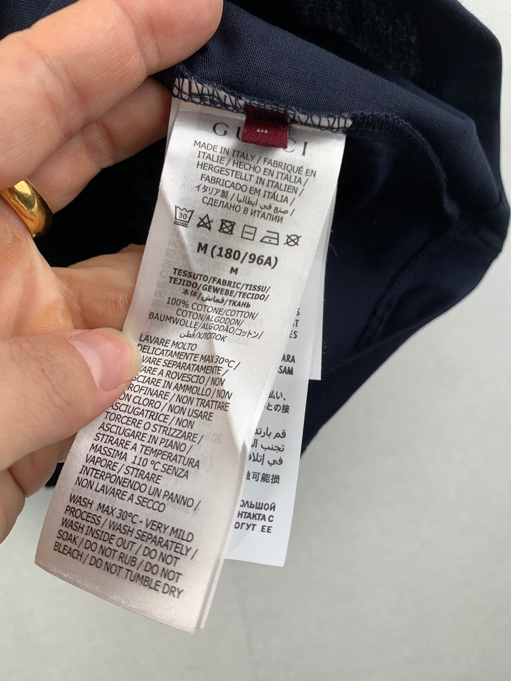 Inside neck care label on navy T-shirt