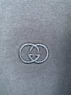 Gucci double-G logo embroidered on blue T-shirt fabric close-up