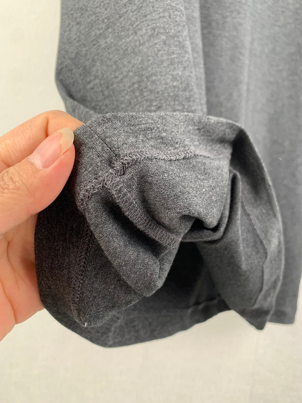Heather gray T-shirt cuff and fold close-up