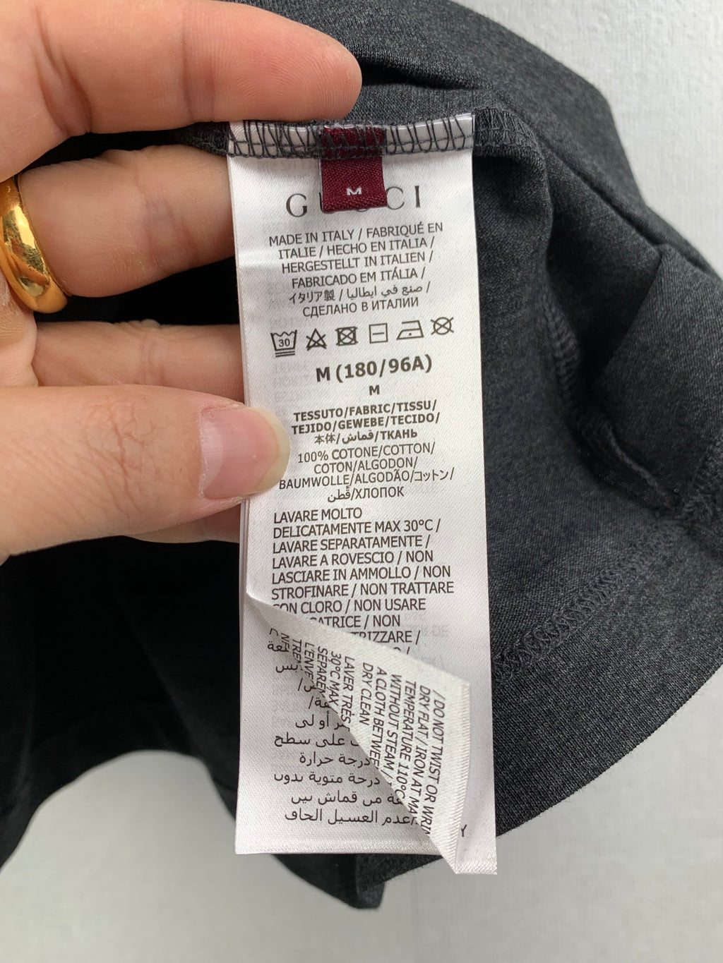 Gucci shorts care label tag stitched on dark fabric
