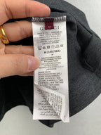 Gucci shorts care label tag stitched on dark fabric