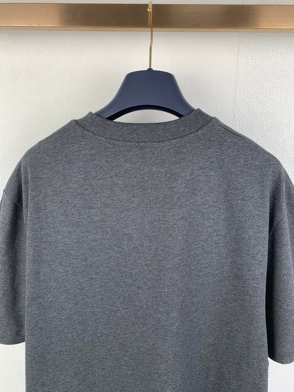 Heather gray crewneck T-shirt back view on hanger