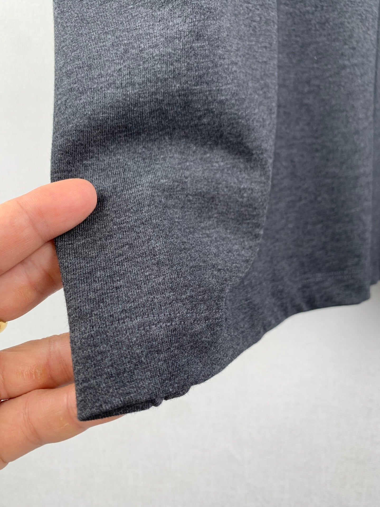 Heather gray T-shirt hem and knit texture close-up