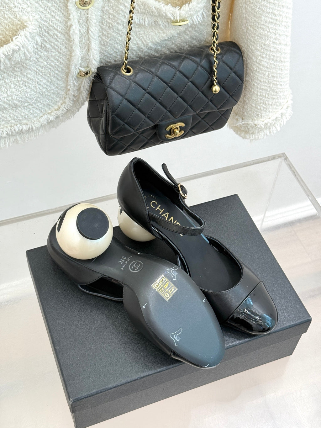 Black slingback flats with pointed toe, glossy cap toe, and cream heel