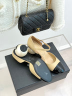 Beige slingback flats with black patent toe cap and bow strap, top view