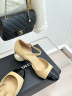 Beige slingback flats with black patent toe cap and bow straps, side view