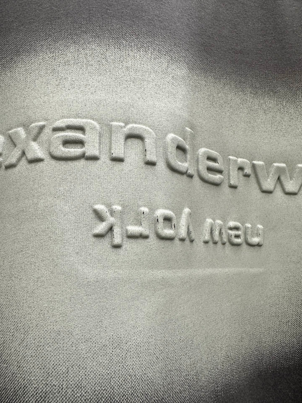 Close-up of dark gray T-shirt logo print and texture
