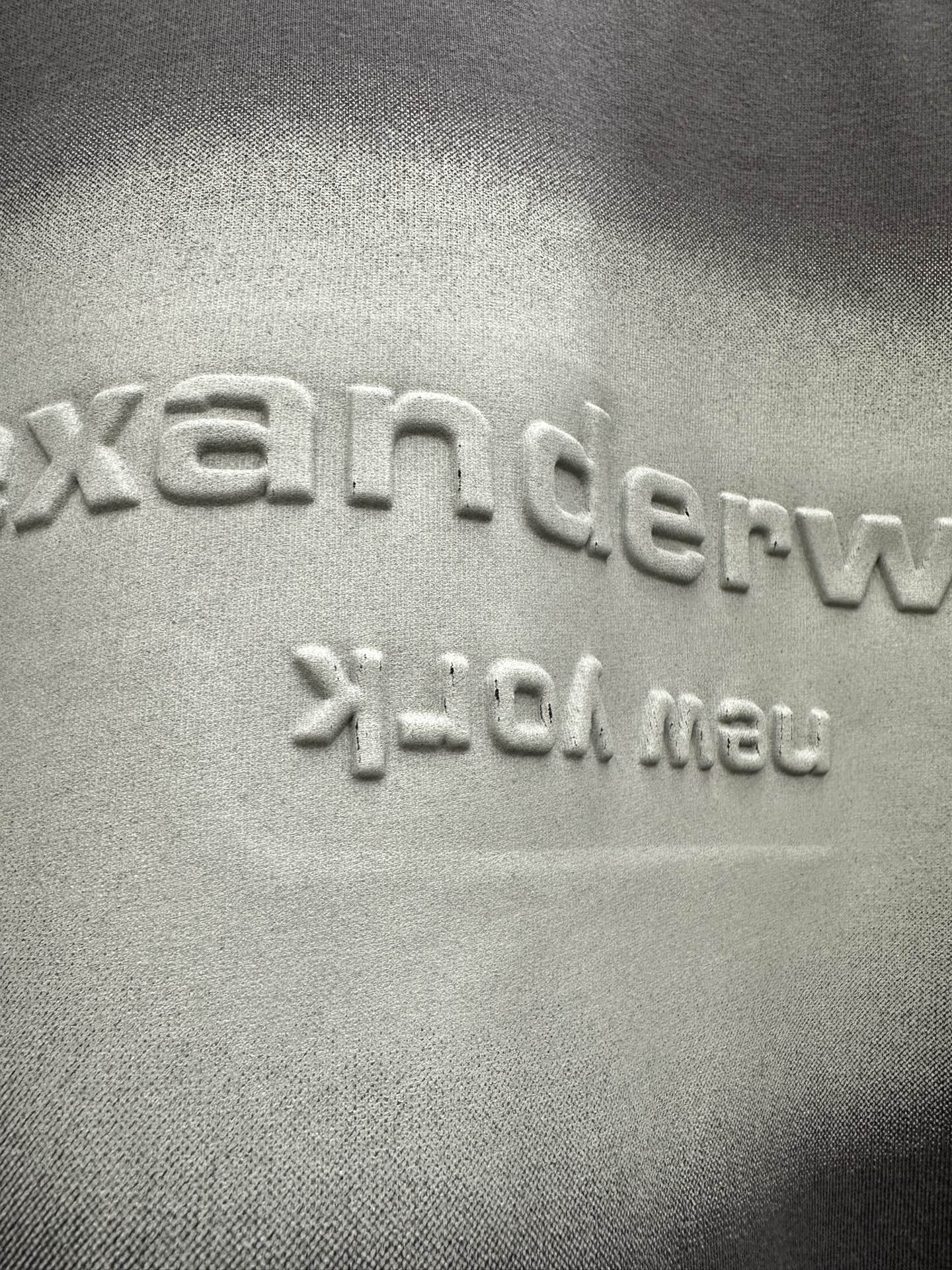 Close-up of dark gray T-shirt logo print and texture