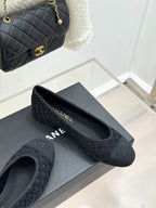 Dark textured ballet flat with CC logo on toe, shown with matching flat