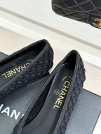 Close-up of dark textured ballet flats with Chanel insole text and heel detail