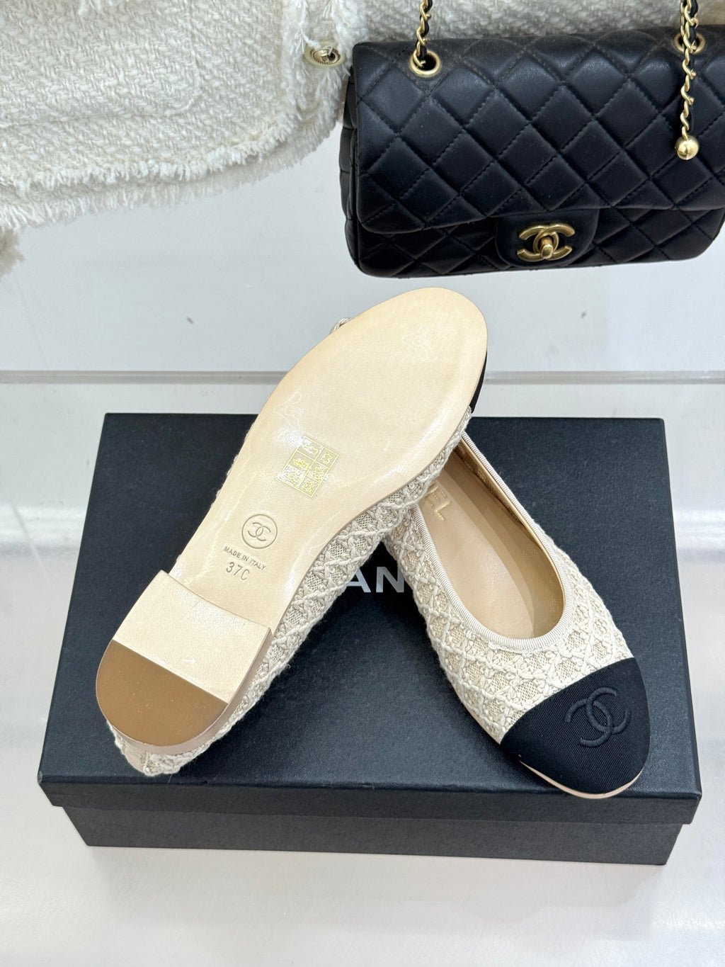 Chanel ballet flats with cream patterned uppers and dark navy logo toe caps on box