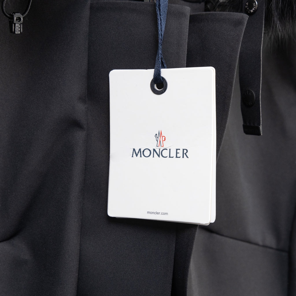Moncler parka front with hanging brand tag and buttoned placket