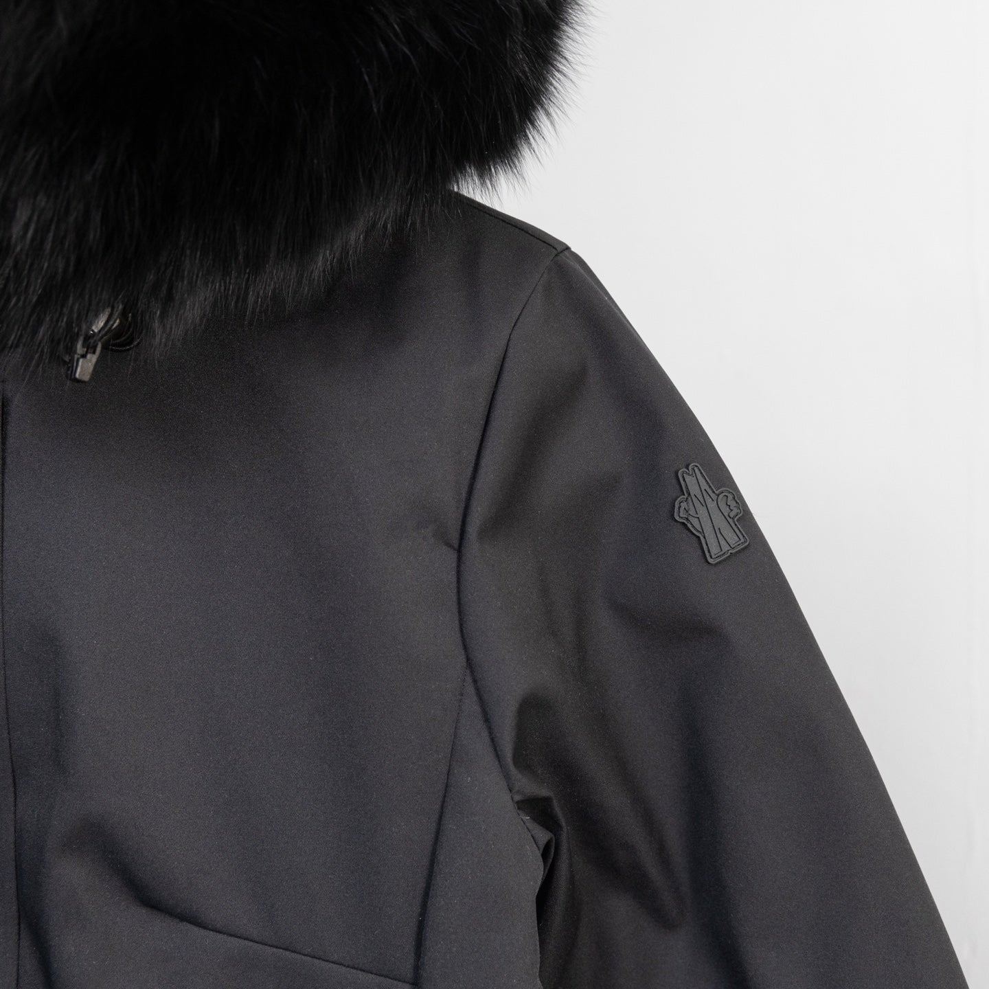 Moncler dark parka sleeve with embroidered logo detail