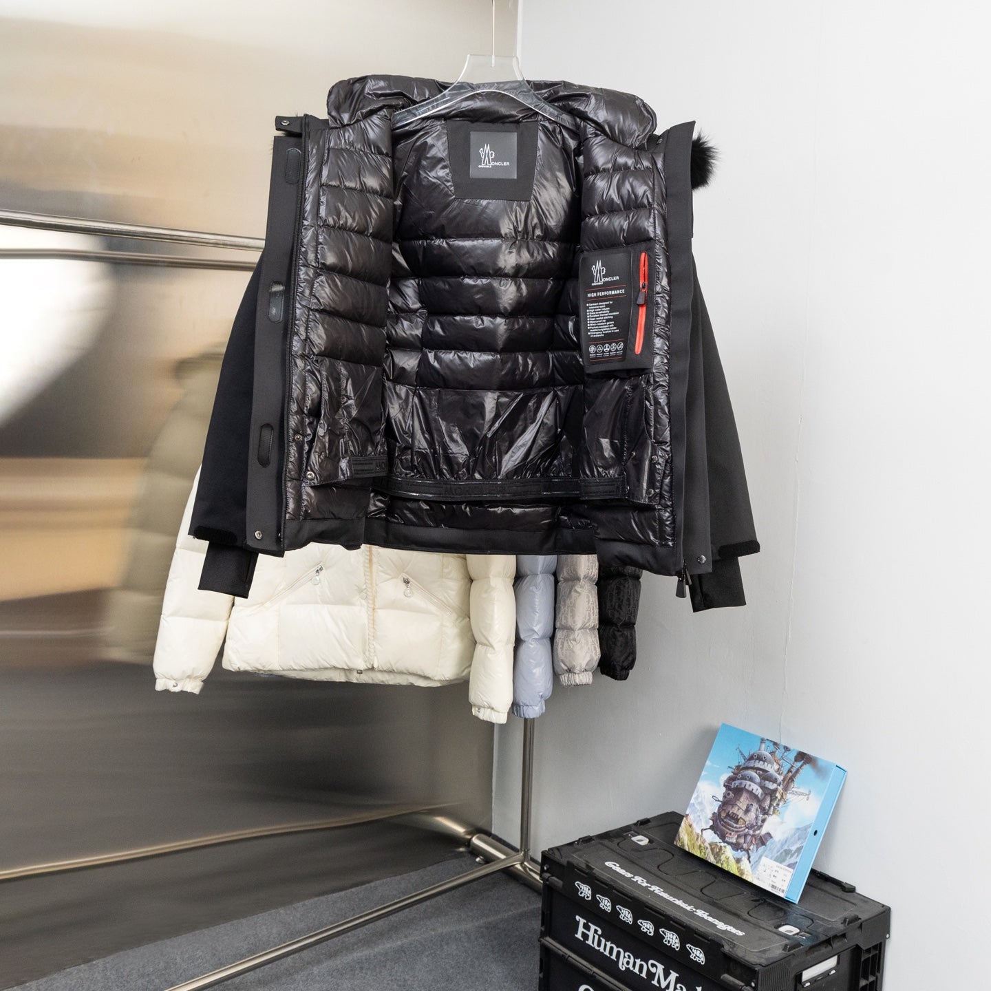 Moncler long parka with black puffer lining, faux-fur hood and front zip