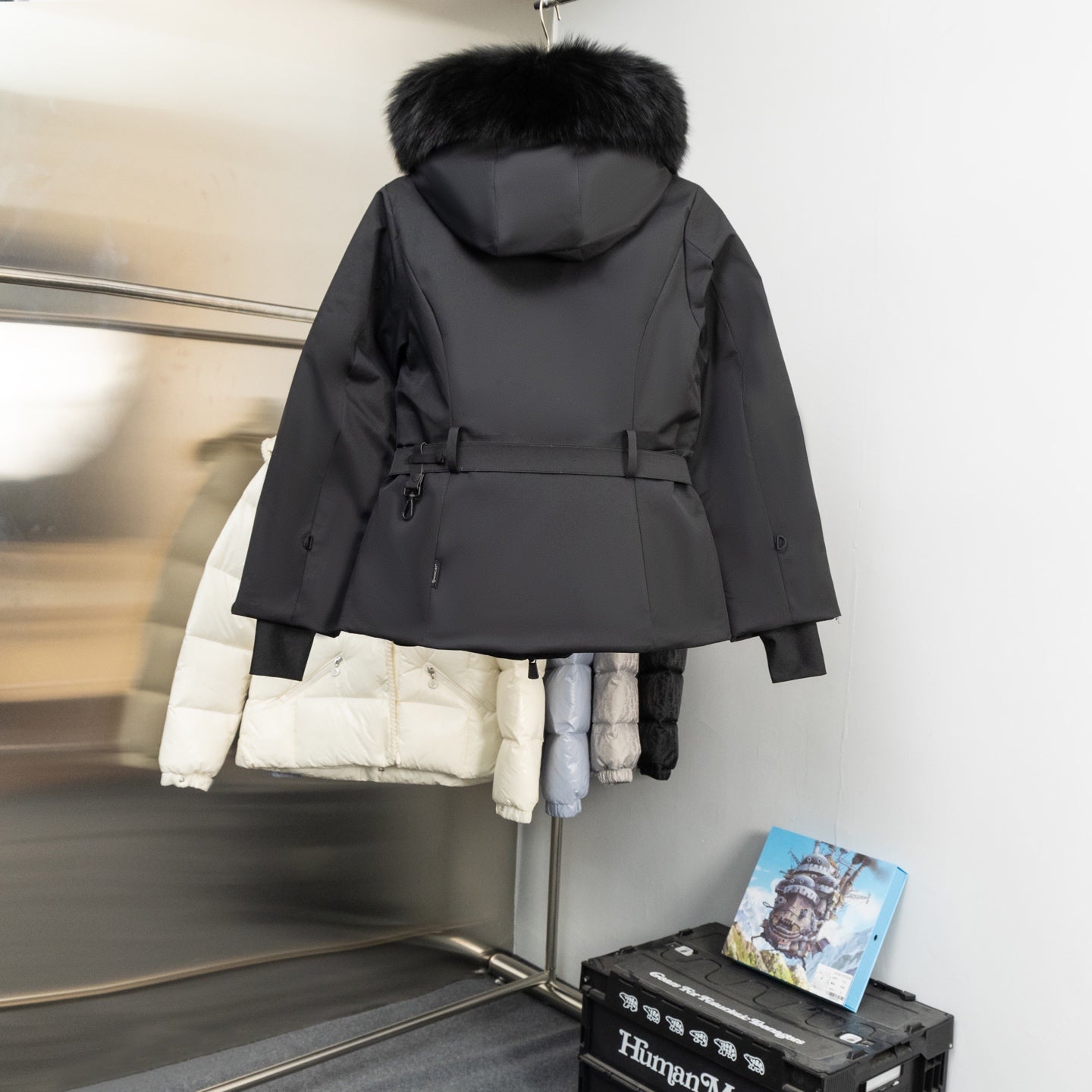 Moncler long parka with faux-fur trimmed hood, dark shell, belted waist and front zip