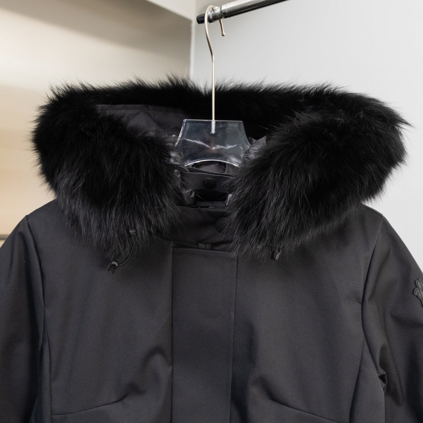 Moncler parka hood with thick faux fur trim and dark front placket