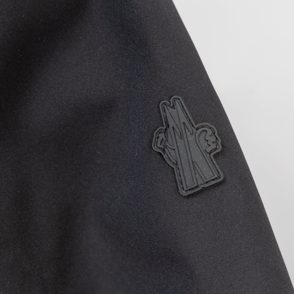 Moncler embroidered logo on dark parka fabric