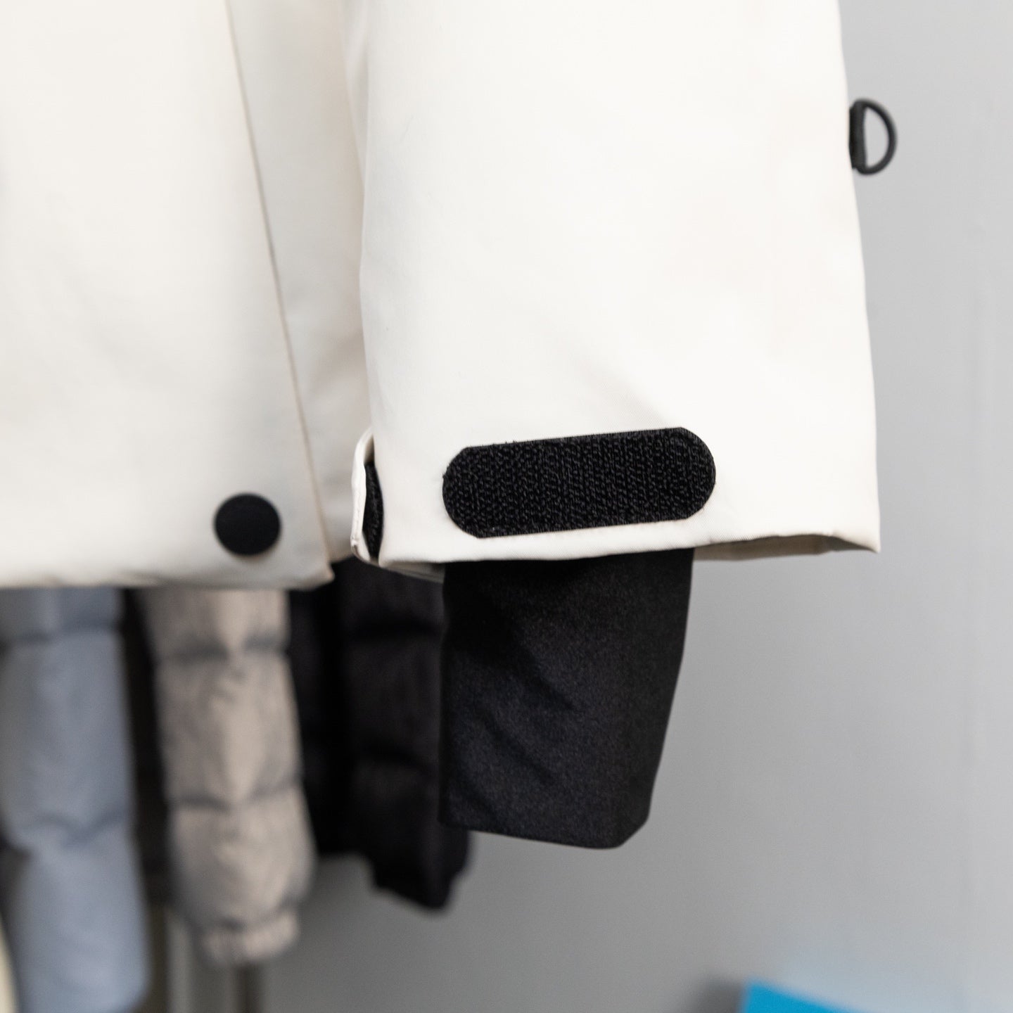 Moncler long coat cuff detail with black patch and snap button