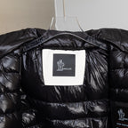 Moncler black puffer jacket interior close-up with logo patch