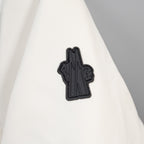 Moncler long coat with small black logo patch on white fabric