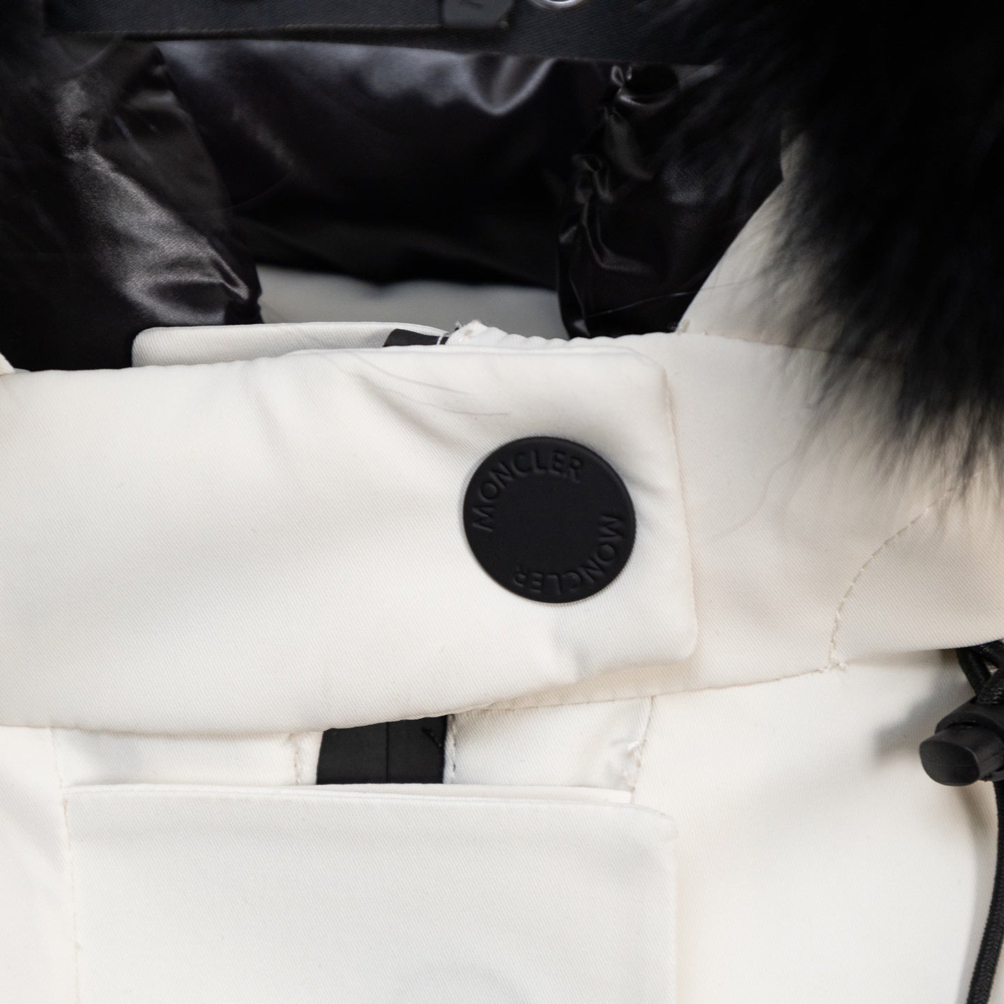 Moncler white puffer sleeve cuff with embossed logo snap button