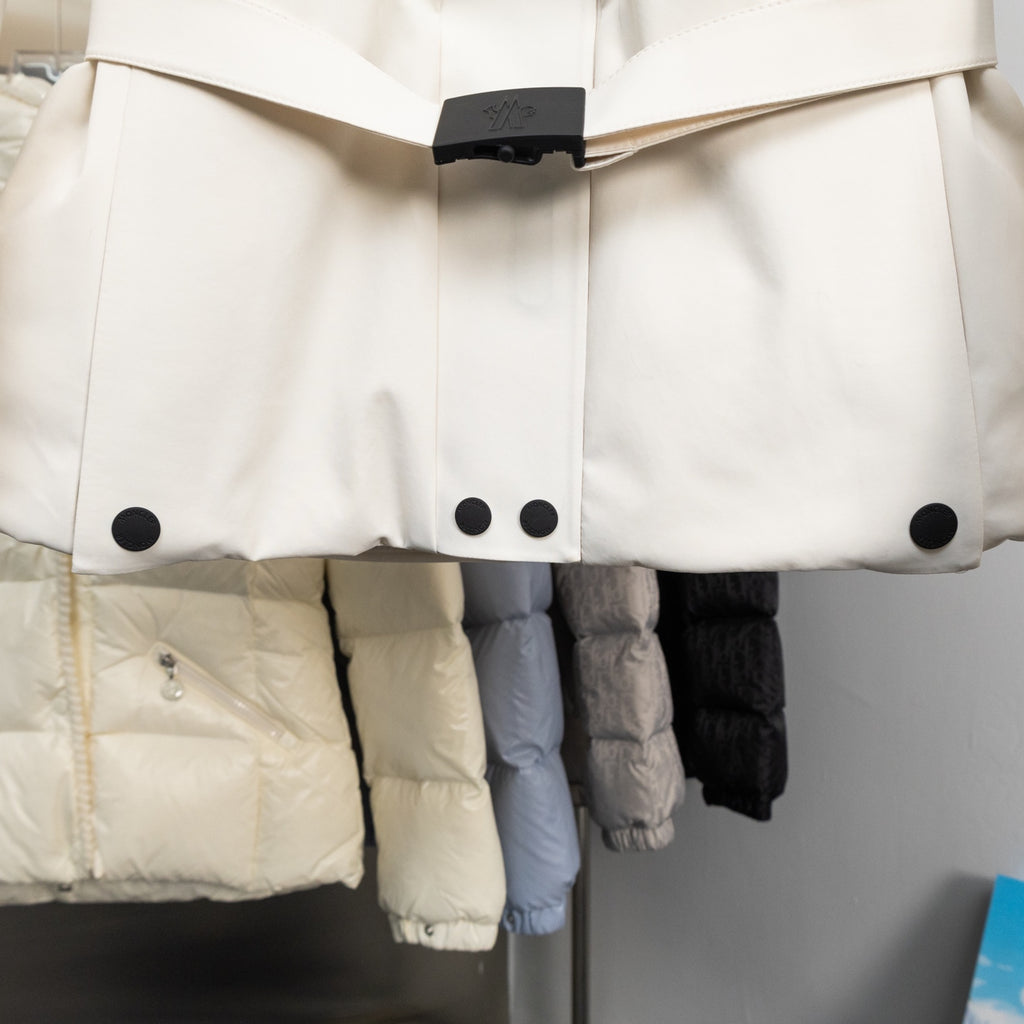 Moncler long coat front with black snap buttons on padded panels