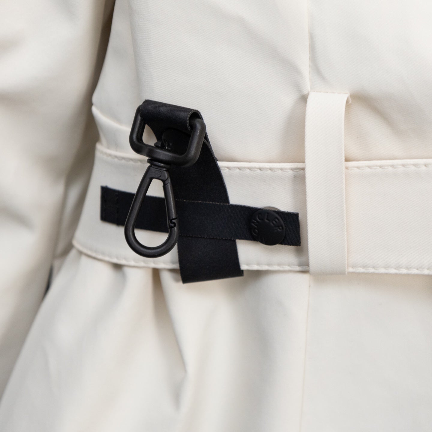 Moncler long coat side strap detail with black buckle