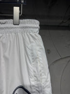 White track pants with elastic waistband and side seam stitching, relaxed fit