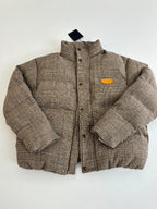 Houndstooth puffer jacket with stand collar, button placket, and orange chest patch