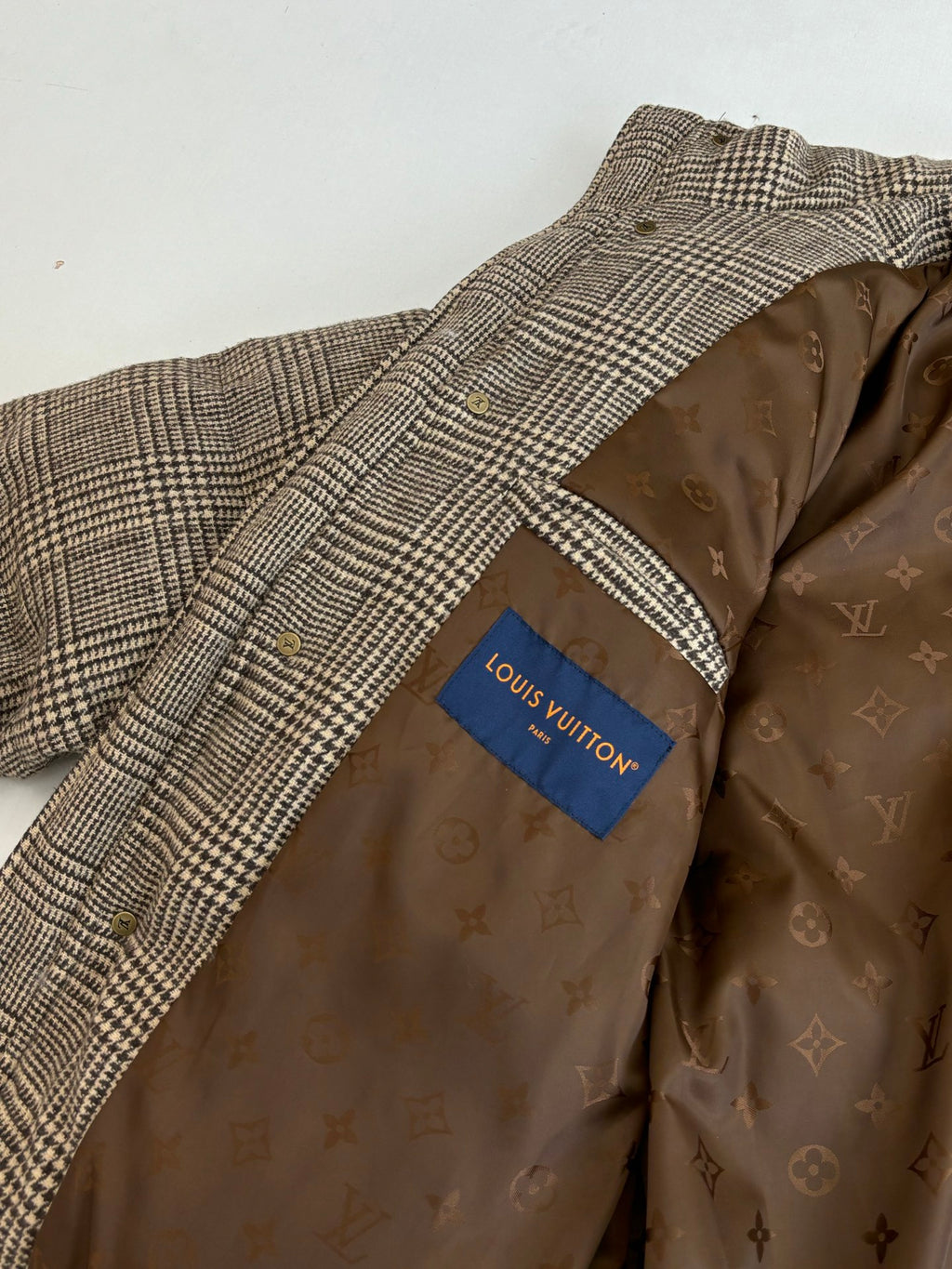 Houndstooth puffer jacket interior lining with monogram print and Louis Vuitton label