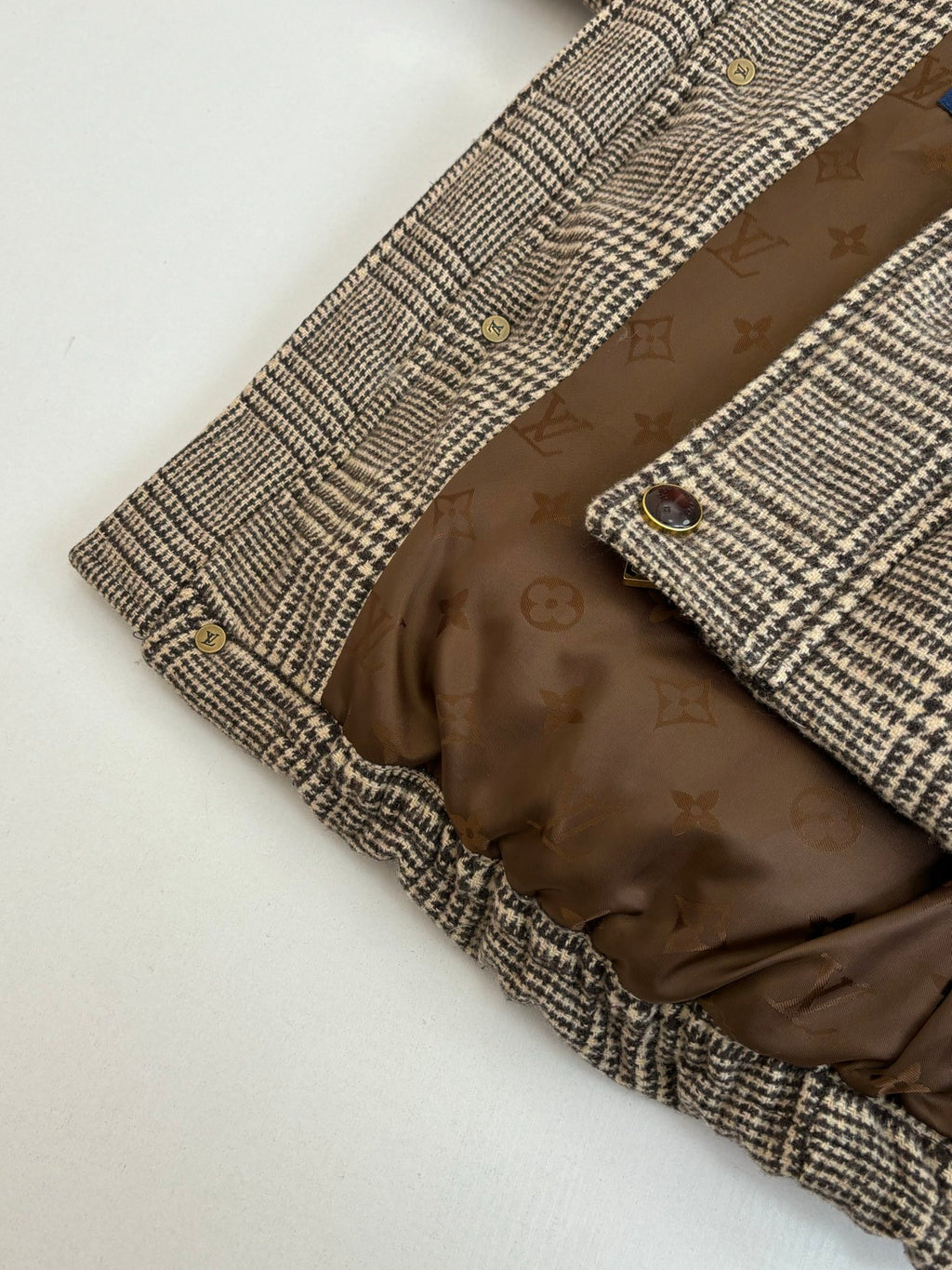 Houndstooth jacket interior with monogram lining and buttoned front placket