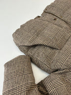 Houndstooth puffer jacket with quilted sleeves and cuffs laid flat for viewing