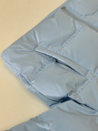 Light blue puffer jacket sleeve with zipper track detail