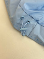 Light blue hooded sweatshirt with drawstring hood and front ties